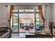 View from inside to a covered patio, featuring an outdoor seating area and stone fire pit at 7036 Winstar St, Las Vegas, NV 89131