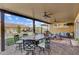 Relaxing covered patio features comfortable seating, ceiling fans, and an inviting outdoor dining area at 7036 Winstar St, Las Vegas, NV 89131