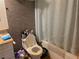 Modest bathroom featuring a standard toilet and shower with neutral-colored tile at 7108 Moon Ct, Las Vegas, NV 89145