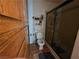 This secondary bathroom features a toilet, storage shelves, and a glass enclosed shower at 7108 Moon Ct, Las Vegas, NV 89145