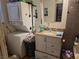 Bathroom with a washing machine and dryer, a vanity sink, and necessary toiletries at 7108 Moon Ct, Las Vegas, NV 89145
