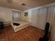 This is a bedroom with a large bed, neutral colored walls, and tile flooring at 7108 Moon Ct, Las Vegas, NV 89145