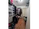 Walk-in closet with metal shelving, clothes hanging on rods, and tiled floor at 7108 Moon Ct, Las Vegas, NV 89145