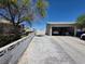 Long driveway leading to a detached garage with block wall at 7108 Moon Ct, Las Vegas, NV 89145