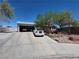 Single story home with a long driveway and desert landscaping at 7108 Moon Ct, Las Vegas, NV 89145