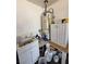 The utility area features a sink, water heater, cabinet, and miscellaneous cleaning supplies at 7108 Moon Ct, Las Vegas, NV 89145