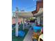 Outdoor patio area shaded by a pergola, furnished with tables and an assortment of toys at 712 Donner St, Las Vegas, NV 89107
