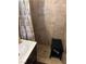 Bathroom shower featuring tiled walls, a black bench, and a floral shower curtain at 712 Donner St, Las Vegas, NV 89107