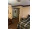 Bedroom featuring mirrored closet doors, neutral walls, and a coordinated plaid bedspread at 712 Donner St, Las Vegas, NV 89107