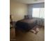 Cozy bedroom showcasing a comfortable bed, side tables, and ample natural light from the window at 712 Donner St, Las Vegas, NV 89107