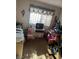 Bedroom with a large window, but full of boxes and toys at 712 Donner St, Las Vegas, NV 89107