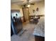 Bright eat-in kitchen with tile floors and stainless steel refrigerator at 712 Donner St, Las Vegas, NV 89107