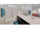 The bathroom offers a bright shower with a built-in seat and a double sink vanity at 794 Sunny Sagebrush St, Henderson, NV 89011