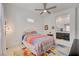 Inviting bedroom with a ceiling fan, bright quilt, and ensuite bathroom offers a serene escape at 794 Sunny Sagebrush St, Henderson, NV 89011