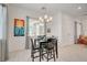 A brightly lit dining area with modern chandelier and neutral decor creates an inviting atmosphere at 794 Sunny Sagebrush St, Henderson, NV 89011