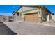 Paver driveway leading to a two-car garage with well maintained landscaping and gated access at 794 Sunny Sagebrush St, Henderson, NV 89011