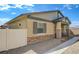Tan single story home with stone accents, low maintenance yard, and desert landscaping at 794 Sunny Sagebrush St, Henderson, NV 89011
