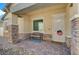 Charming front porch featuring stone accents, a seating bench and a secured front door at 794 Sunny Sagebrush St, Henderson, NV 89011