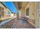 Covered front porch with stone accents, a sitting bench, and a decorative secure front door at 794 Sunny Sagebrush St, Henderson, NV 89011