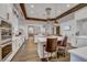 Gourmet kitchen with stainless steel appliances, white cabinets, and a large center island with bar seating at 794 Sunny Sagebrush St, Henderson, NV 89011