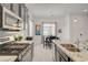 Well-appointed kitchen with stainless steel appliances, granite countertops and adjacent dining area at 794 Sunny Sagebrush St, Henderson, NV 89011