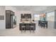 The kitchen features dark cabinetry, tile floors, stainless appliances, granite counters, and a dining area at 794 Sunny Sagebrush St, Henderson, NV 89011