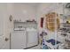 Convenient laundry room with modern washer, dryer, storage shelves, and practical layout at 794 Sunny Sagebrush St, Henderson, NV 89011