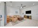Cozy living room with a ceiling fan, tan sofa, and decorative rug offers a comfortable retreat at 794 Sunny Sagebrush St, Henderson, NV 89011