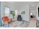 Cozy sitting room featuring a comfortable recliner and a door leading to the kitchen at 794 Sunny Sagebrush St, Henderson, NV 89011