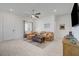 Comfortable living room with ample natural light, ceiling fan, and neutral walls offers relaxation at 794 Sunny Sagebrush St, Henderson, NV 89011