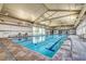Inviting indoor pool with a high ceiling, natural light, and plenty of space for swimming laps at 794 Sunny Sagebrush St, Henderson, NV 89011