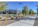 Well maintained tennis court area with landscaping, walking paths, and lights for evening play at 794 Sunny Sagebrush St, Henderson, NV 89011