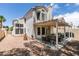 Cozy covered patio and gravel yard perfect for outdoor entertaining and relaxation in this backyard view at 8021 Hilliard Ave, Las Vegas, NV 89128