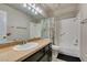 Hall bath with shower-tub combo, single vanity and granite counter at 8021 Hilliard Ave, Las Vegas, NV 89128