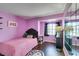 Purple bedroom featuring unique decor, wood floors, and large mirror at 8021 Hilliard Ave, Las Vegas, NV 89128