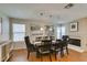 Spacious dining room with an ample table and chairs, contemporary light fixtures, and neutral decor at 8021 Hilliard Ave, Las Vegas, NV 89128