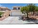Charming two-story home with a well-maintained front yard, a garage, and desert landscaping at 8021 Hilliard Ave, Las Vegas, NV 89128
