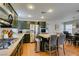 Open kitchen featuring stainless steel appliances, dark cabinetry and wooden floors at 8021 Hilliard Ave, Las Vegas, NV 89128