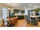 Modern kitchen features an island with seating, stainless steel appliances, and a cozy breakfast nook at 8021 Hilliard Ave, Las Vegas, NV 89128