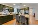Modern kitchen with stainless steel appliances, center island and dark green cabinetry at 8021 Hilliard Ave, Las Vegas, NV 89128
