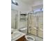Bathroom with shower-tub combo, vanity, mirror, and a window at 8900 Big Bear Pines Ave, Las Vegas, NV 89143
