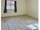 Bedroom featuring a window to let in natural light and tile floor at 8900 Big Bear Pines Ave, Las Vegas, NV 89143