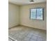 Bedroom featuring a window to let in natural light and tile floor at 8900 Big Bear Pines Ave, Las Vegas, NV 89143