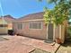 Exterior view features pavers, tan stucco, and windows on back of home at 8900 Big Bear Pines Ave, Las Vegas, NV 89143