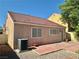 View of a charming home with a brick-paved backyard, set against a clear blue sky and lush trees at 8900 Big Bear Pines Ave, Las Vegas, NV 89143