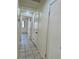 Hallway with access to different rooms, neutral paint and tile floor at 8900 Big Bear Pines Ave, Las Vegas, NV 89143