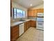 Well-lit kitchen featuring tile floors, natural wood cabinetry, and a view from the large window at 8900 Big Bear Pines Ave, Las Vegas, NV 89143