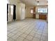 Spacious living area featuring neutral tile flooring, bright windows, and an open floor plan at 8900 Big Bear Pines Ave, Las Vegas, NV 89143