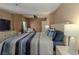 Cozy bedroom featuring a large bed with a striped comforter, plus a TV and dresser at 920 Biltmore Dr, Las Vegas, NV 89101