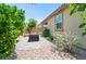 Private backyard features mature landscaping, rock groundcover and brick paved area at 9288 Valley Betica Ave, Las Vegas, NV 89148